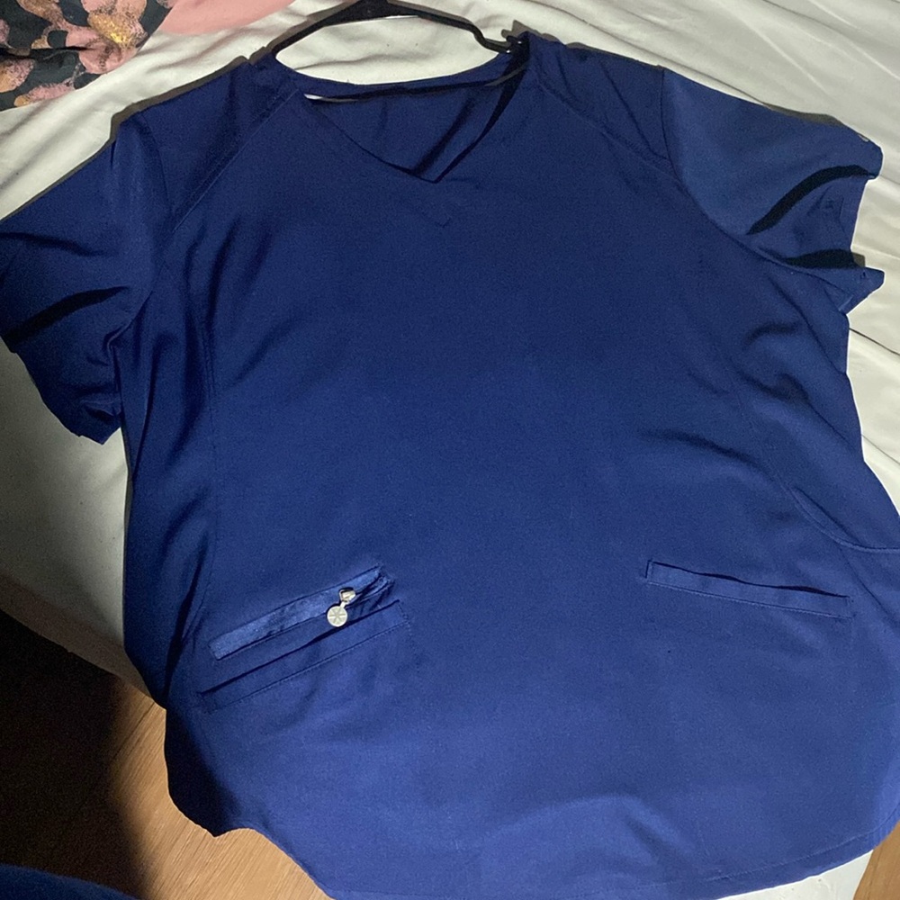 Navy blue women’s scrubs. They are cuffed at the bottom of the scrub pants